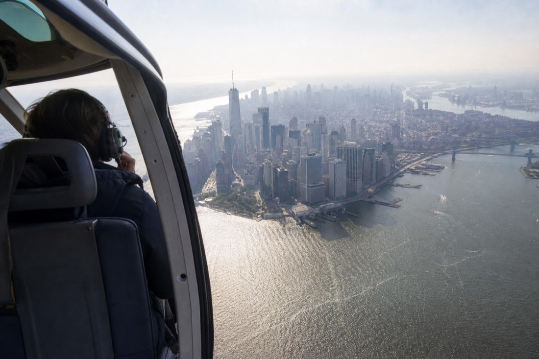 Sightseeing helicopter passing the Lower Manhattan financial district skyscrapers